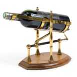 Brass mechanical action wine bottle stand/pourer on wooden base with a bottle of 2015 Chateau de