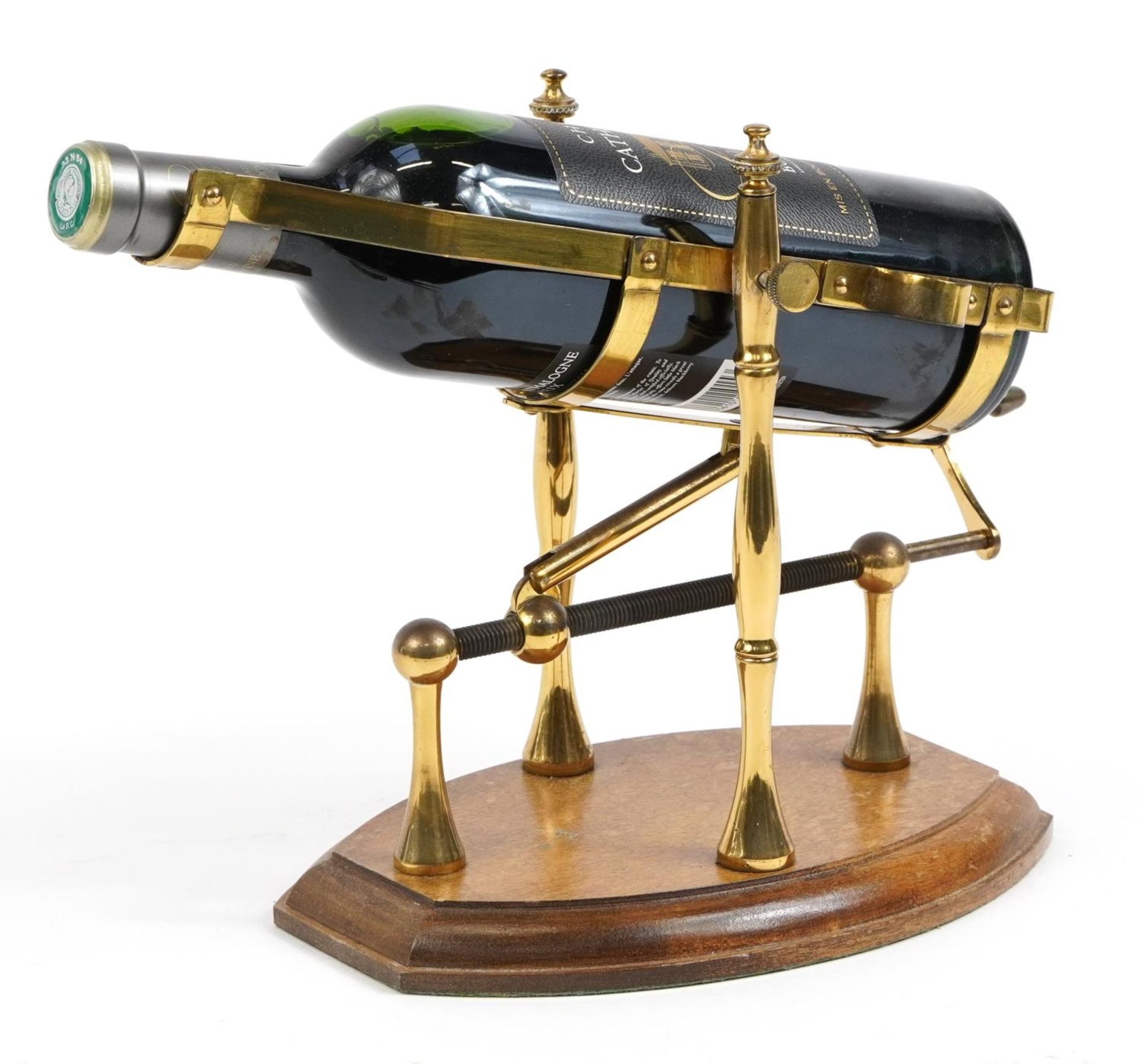 Brass mechanical action wine bottle stand/pourer on wooden base with a bottle of 2015 Chateau de