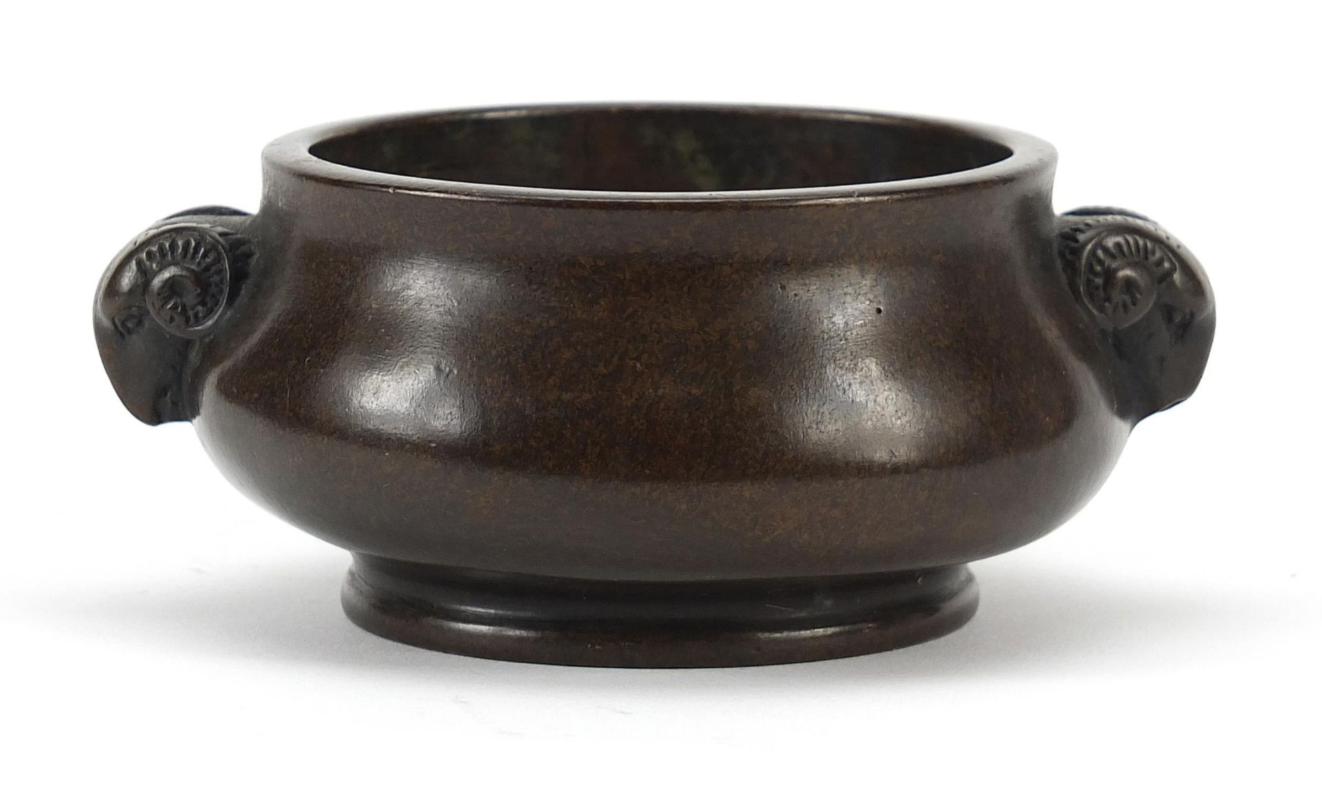 Chinese patinated bronze censer with ram's head handles, character marks to the base, 11cm wide