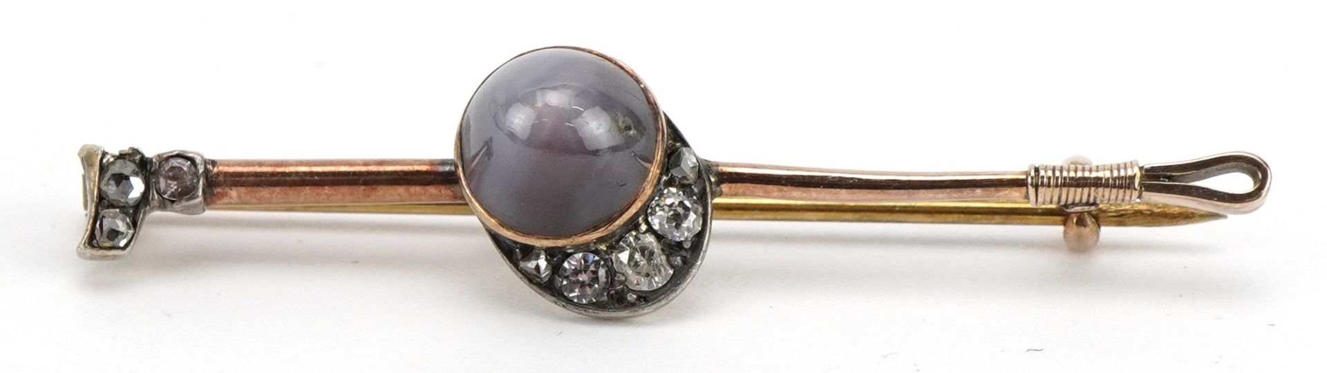 Equestrian interest unmarked gold cabochon star sapphire and diamond bar brooch in the form of a