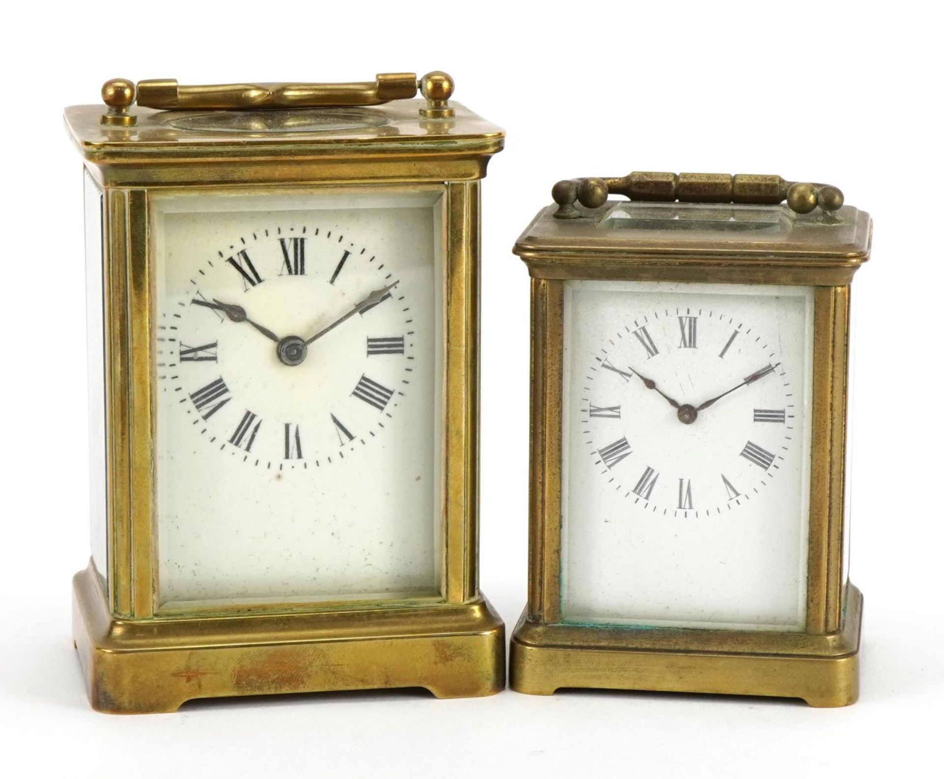 Two brass cased carriage clocks with enamelled dials and Roman numerals, the largest 11cm high