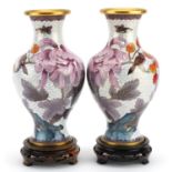 Pair of Chinese cloisonne vases raised on hardwood stands, each enamelled with birds amongst