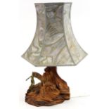 Naturalistic driftwood table lamp with shade mounted with a bronzed nude Art Deco female, 69cm high