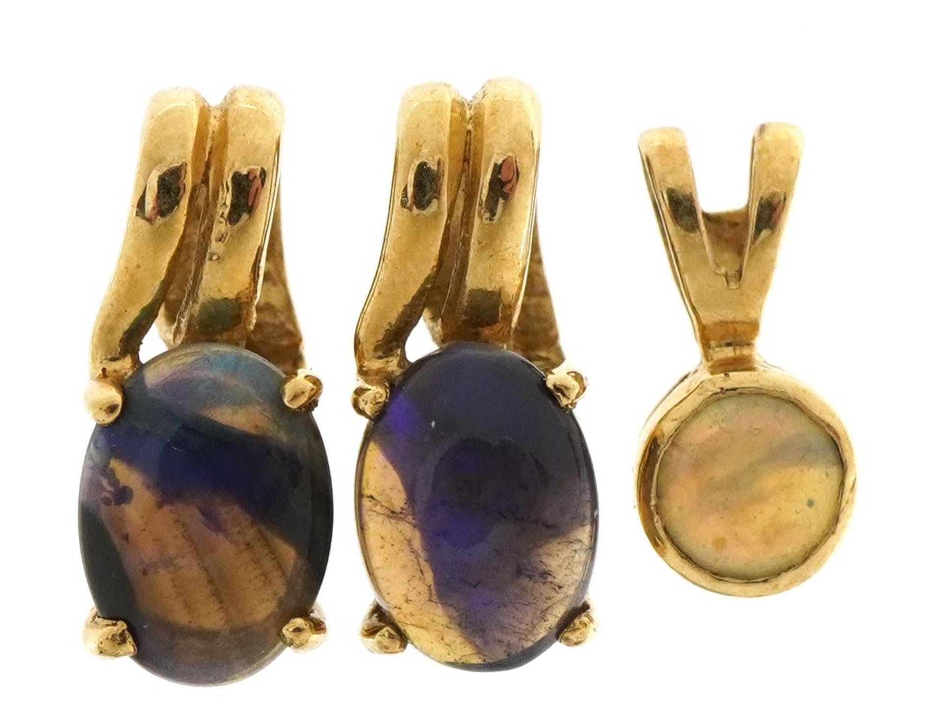 Three 9ct gold opal solitaire pendants, the largest 1.2cm high, total 1.7g