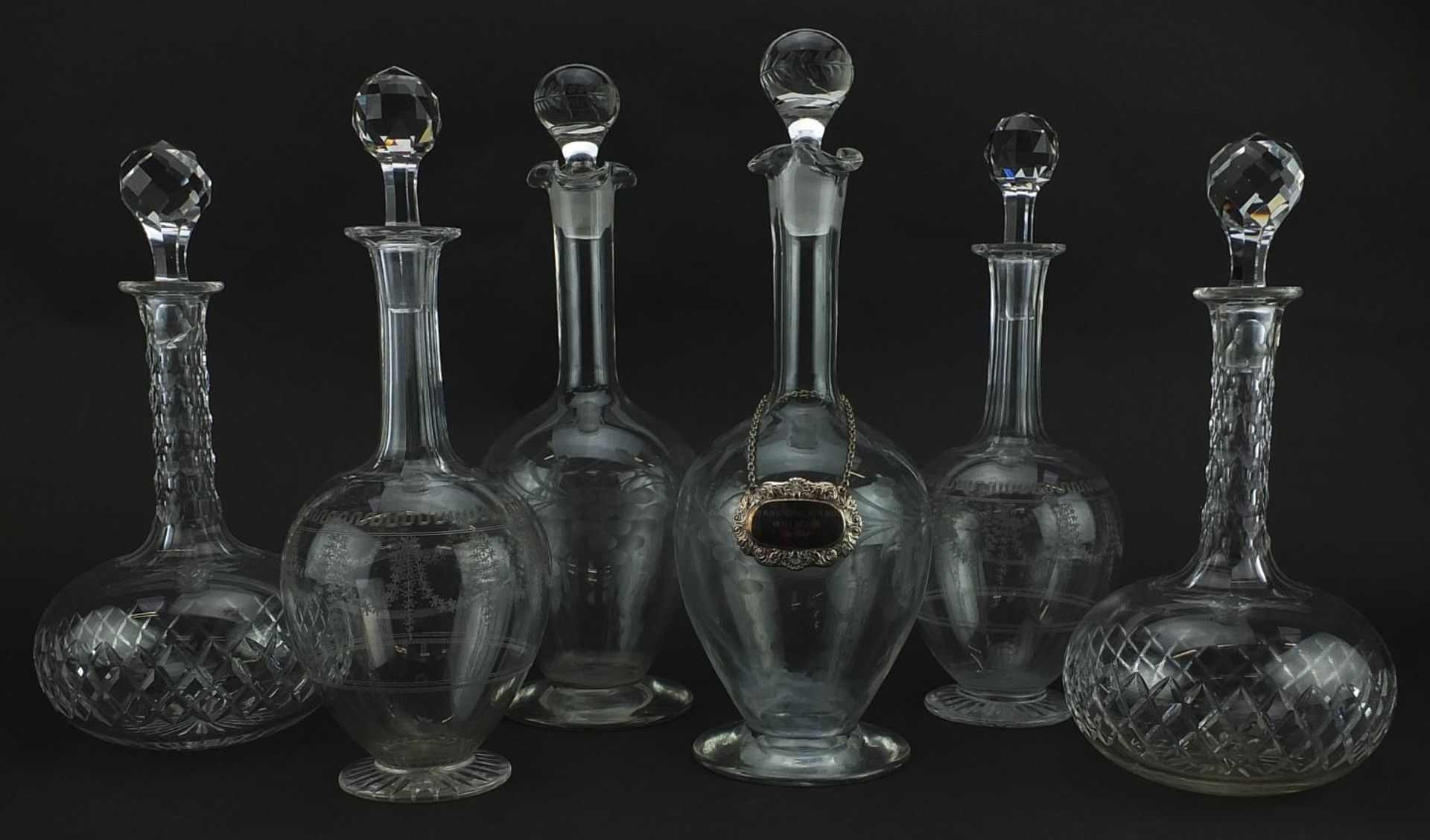 Six glass decanters including a pair of cut examples, the largest 33.5cm high