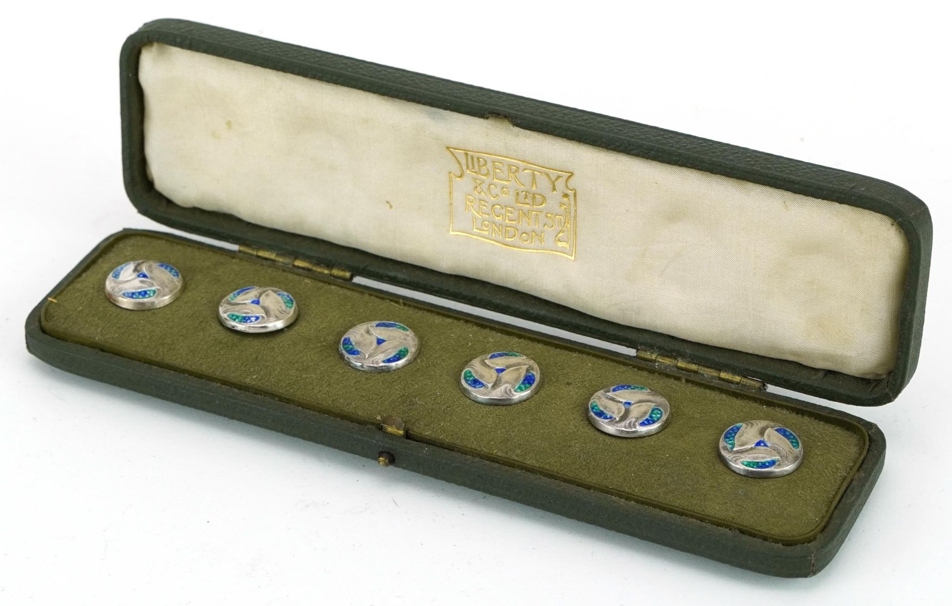 Archibald Knox for Liberty & Co, set of six Arts & Crafts silver and enamel Cymric buttons, housed