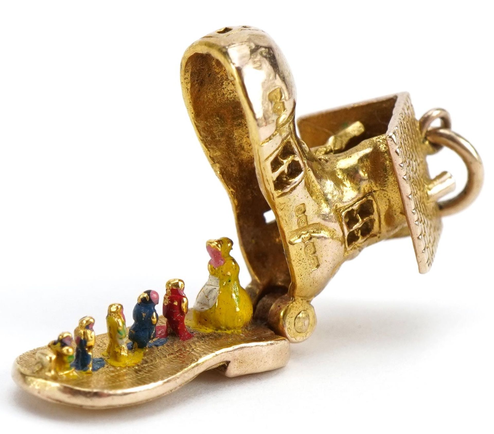 9ct gold shoe charm opening to reveal enamelled figures, 1.5cm high, 3.8g