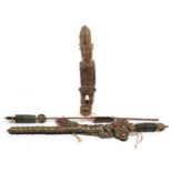 Tribal interest carved wood figure and two Chinese cash coins design swords, the largest 44cm in