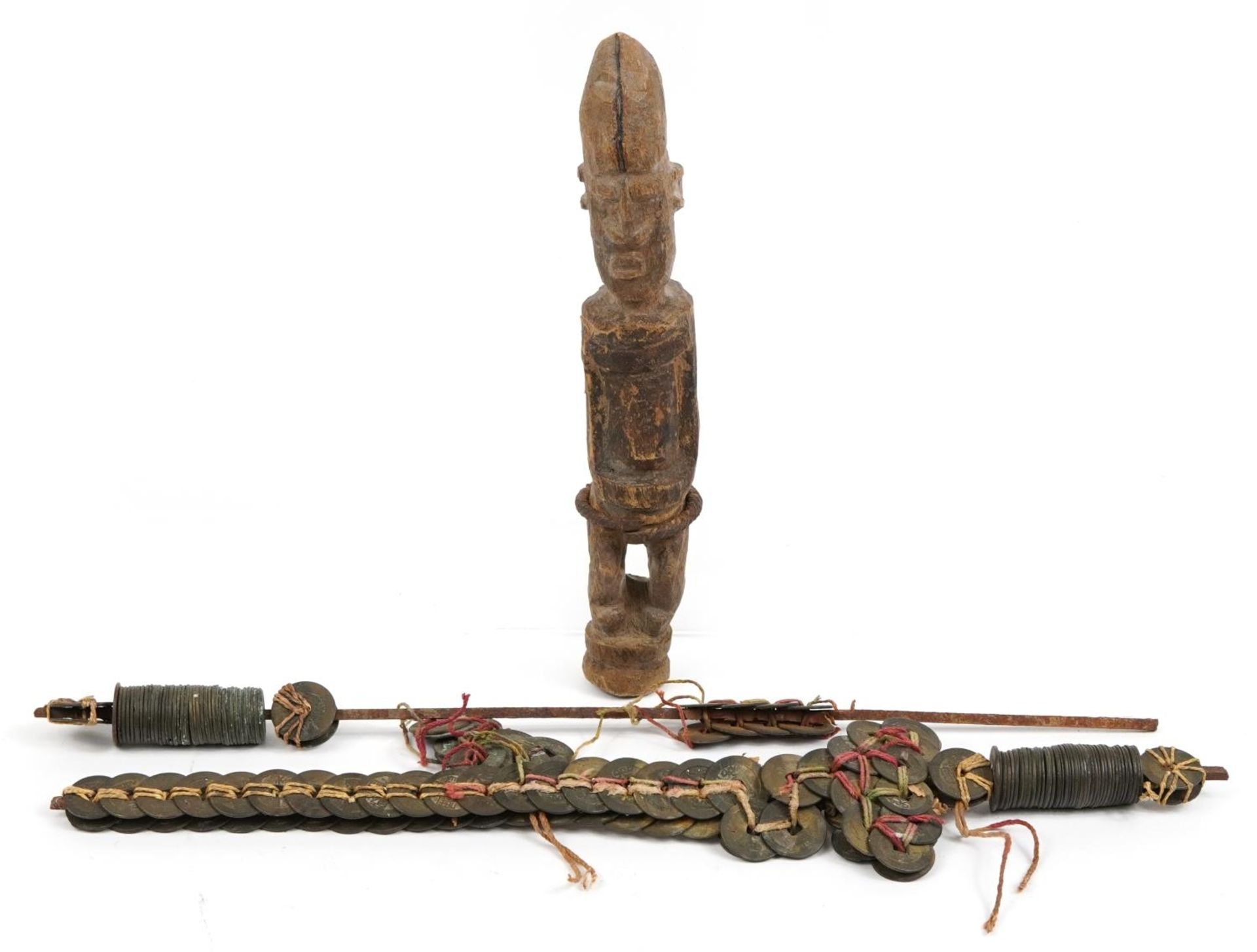 Tribal interest carved wood figure and two Chinese cash coins design swords, the largest 44cm in