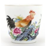 Chinese porcelain teacup hand painted in the famille rose palette with a chicken amongst flowers,