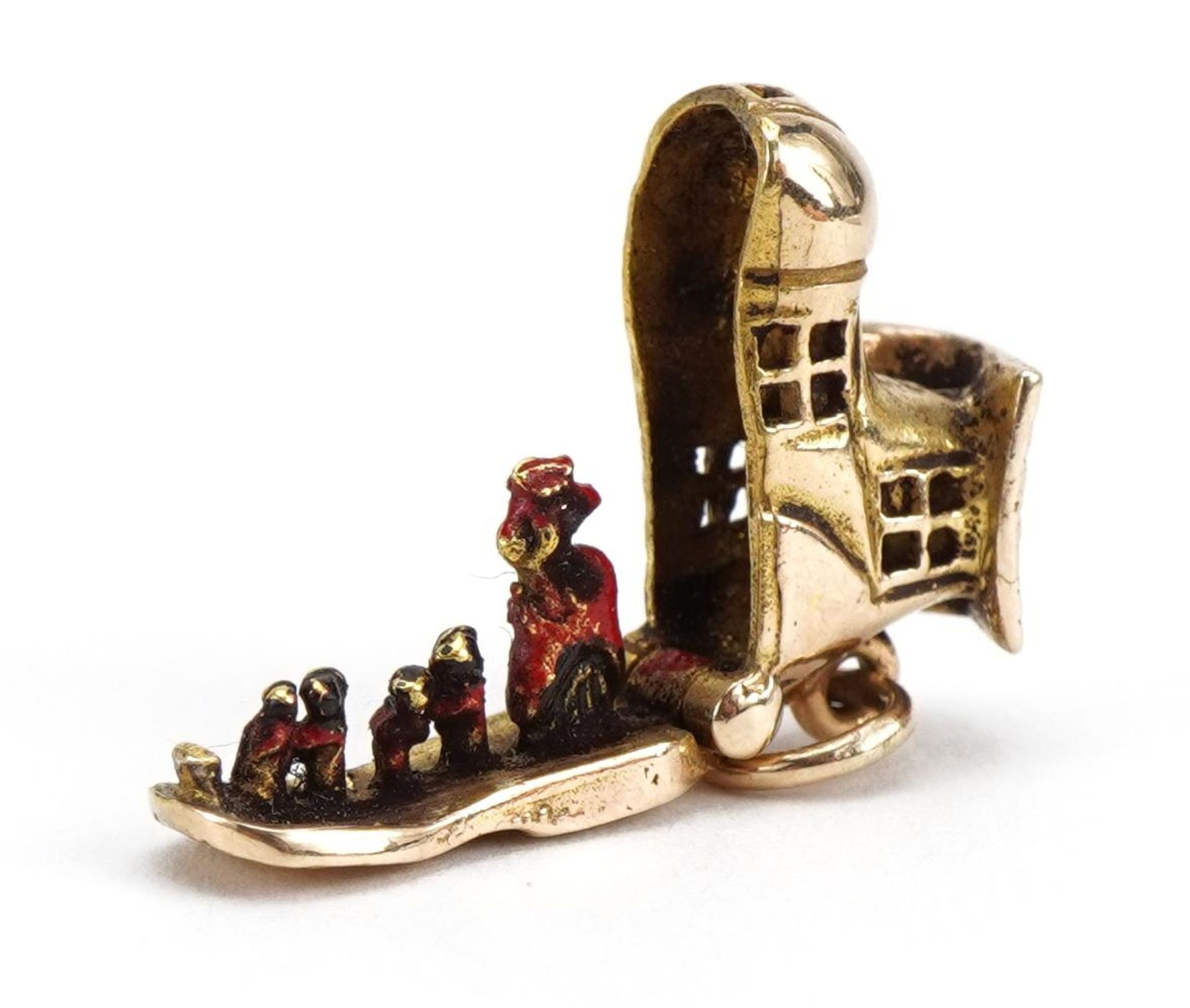 9ct gold shoe charm opening to reveal enamelled figures, 1.5cm wide, 2.7g