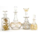 Four 19th century French glass decanters with gilt decoration, the largest 17.5cm high