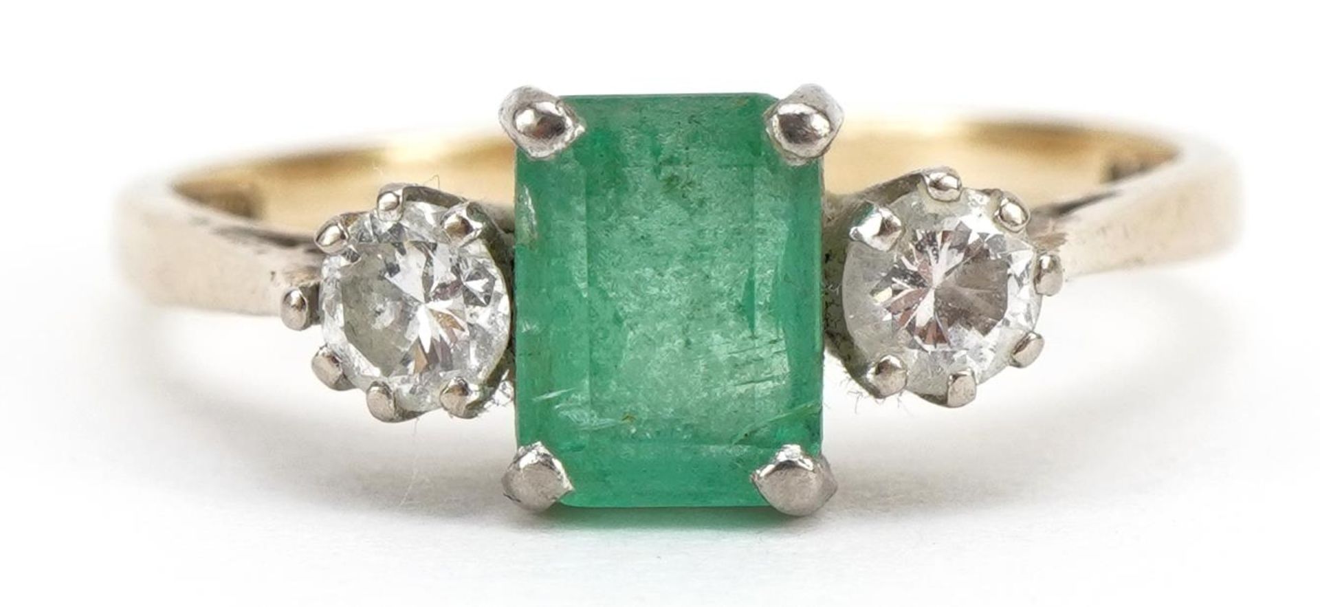 9ct gold emerald and diamond three stone ring, the emerald approximately 6.8mm x 4.8mm, each diamond