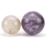 Two crystal balls including an amethyst example, the largest 11cm in diameter