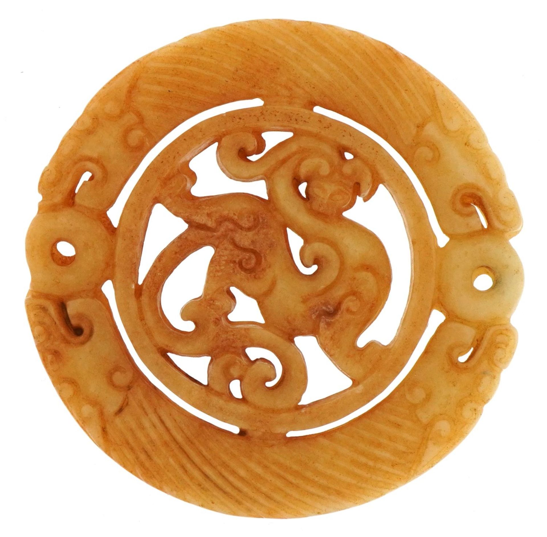 Chinese russet hardstone disk carved with dragons, 7.2cm in diameter, 53.5g