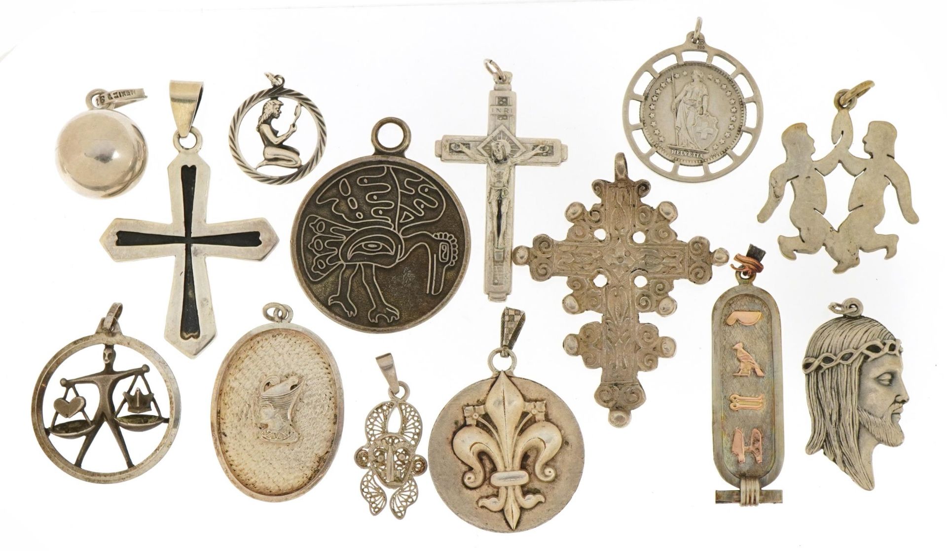 Silver and white metal pendants including Rococo style cross, Nefertiti and fleur de lis Joan of