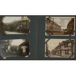 Edwardian and later postcards arranged in an album, some photographic including Hastings, Dunster,