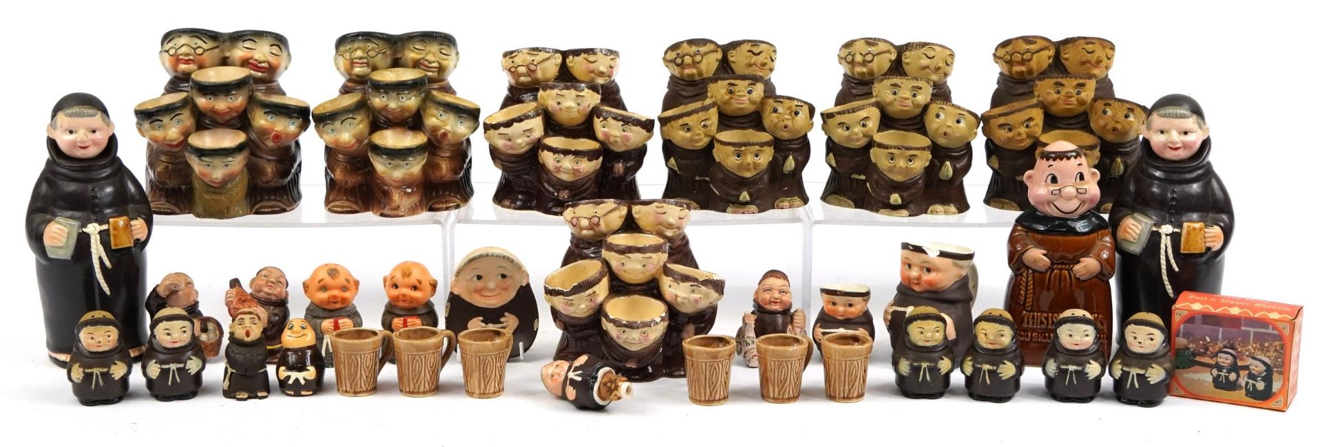 Collection of monk design decanters, egg cups and figures including Goebel, the largest 22cm high