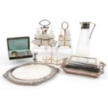Silver plate and glassware including cruet sets, entree dish with cover and a claret jug, the