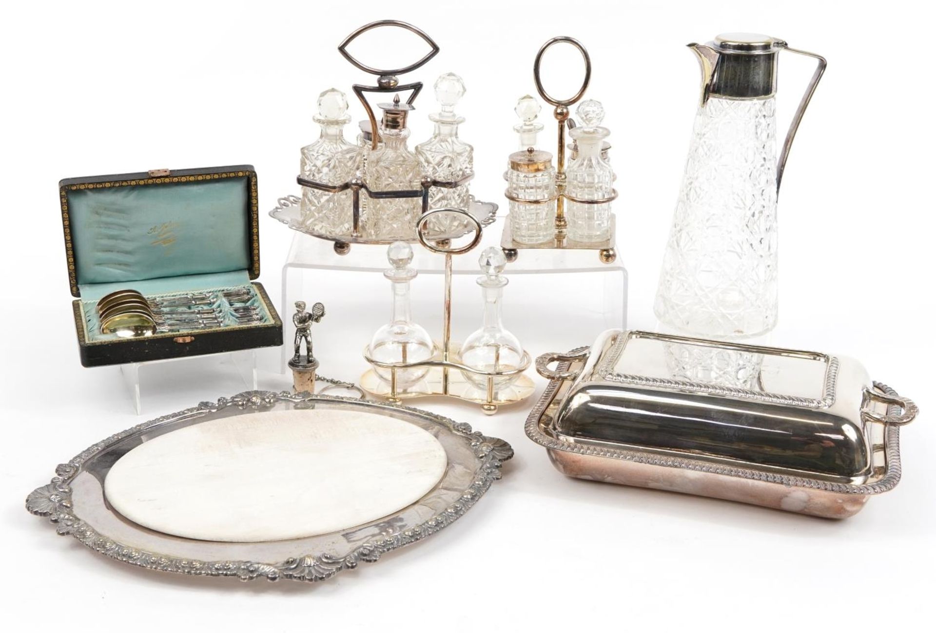 Silver plate and glassware including cruet sets, entree dish with cover and a claret jug, the