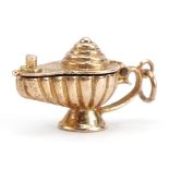 9ct gold genie oil lamp charm opening to reveal a figure, 2.3cm wide, 3.0g