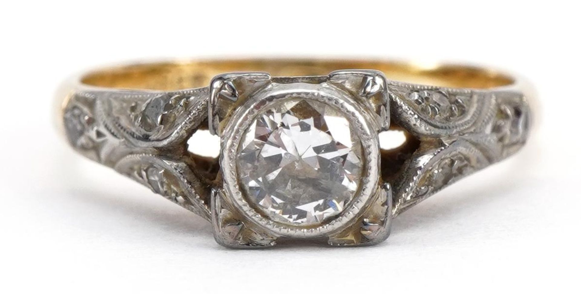 18ct gold and platinum diamond ring with diamond set shoulders, the central diamond approximately