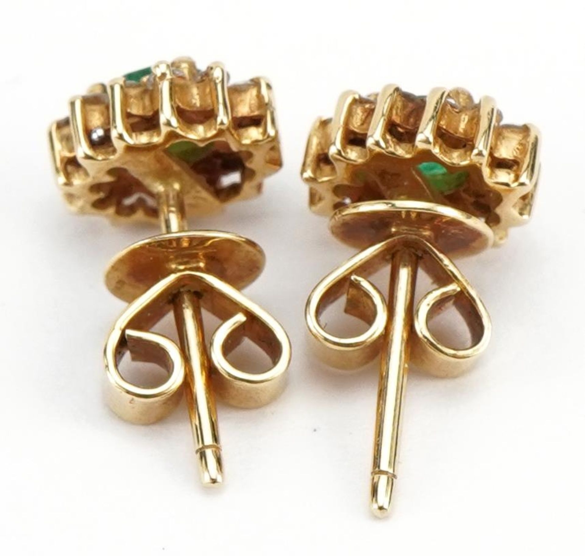 Pair of unmarked gold emerald and diamond cluster stud earrings, the backs marked 750, 8mm high, 2. - Image 2 of 2