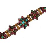 Continental gilt metal flower head multigem bracelet, set with colouful stones including rubies,