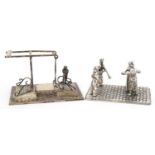 Two miniature Dutch silver models of figures dancing and a figure waiting to cross a bridge, the