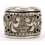 Chinese silver coloured metal archer's ring decorated with figures, 3cm in diameter