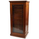 Victorian mahogany floor standing specimen chest with glazed door enclosing sixteen drawers, 149cm H