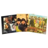 Three Beatles vinyl LP records including Sgt Pepper's Lonley Hearts Club Band with cut out and