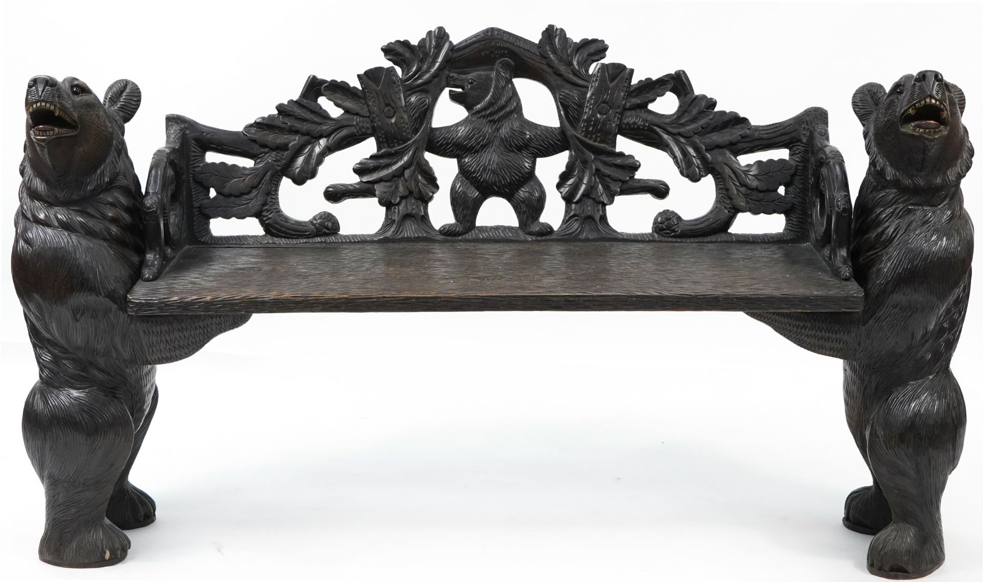 Swiss Black Forest carved bear bench with two standing bears holding a carved backrest decorated