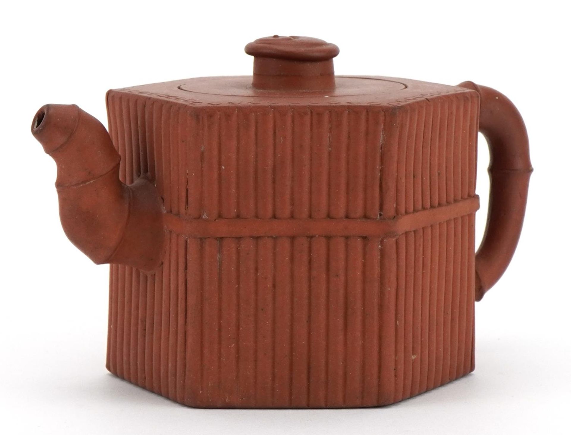 Chinese Yixing terracotta teapot with hexagonal body, impressed character marks to the base, 16.