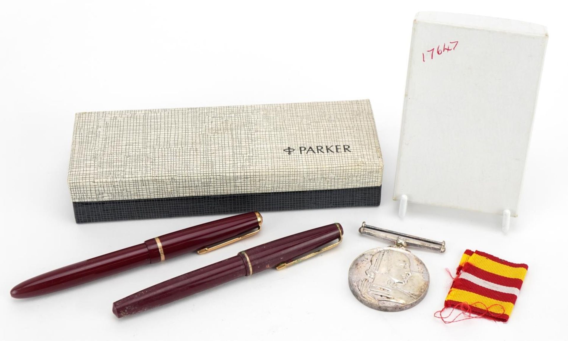 Two vintage Parker fountain pens, one with 14ct gold nib and a St John Ambulance medal awarded to