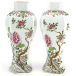 Pair of Chinese porcelain hexagonal vases hand painted in the famille rose palette with flowers,