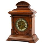 Edwardian oak striking mantle clock, the gilt dial having Roman numerals, Oetzmann & Co label to the