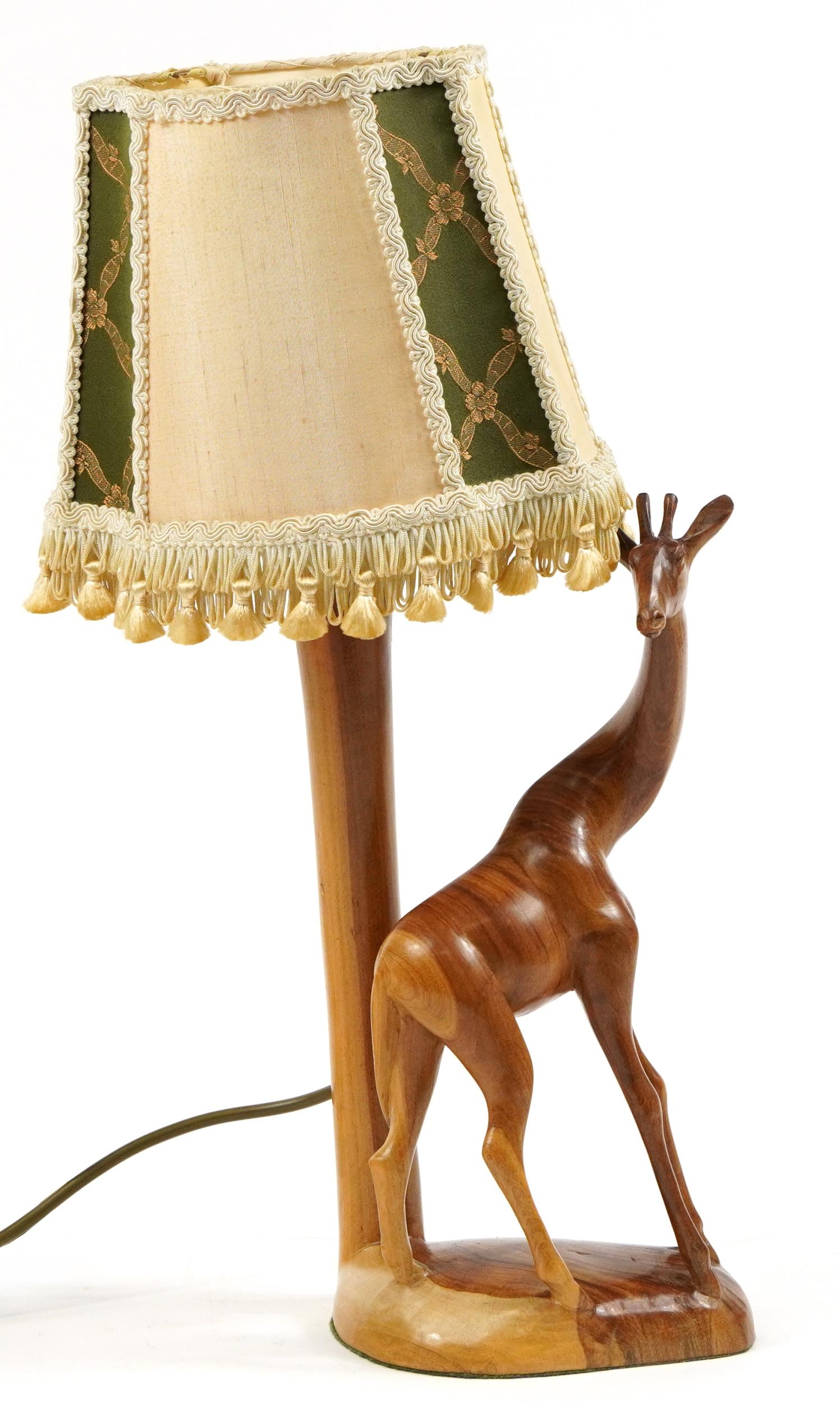 African carved wood table lamp with shade in the form of a giraffe, 48cm high