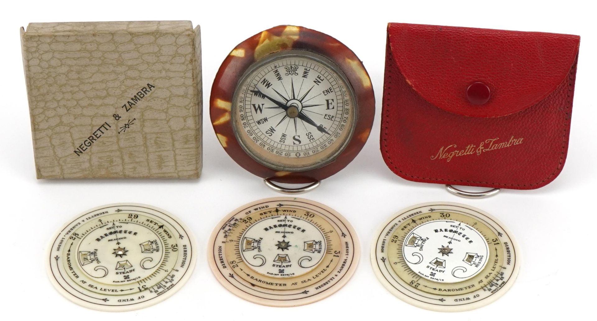 Three Negretti & Zambra pocket weather forecasters and a desk compass with faux tortoiseshell mount,