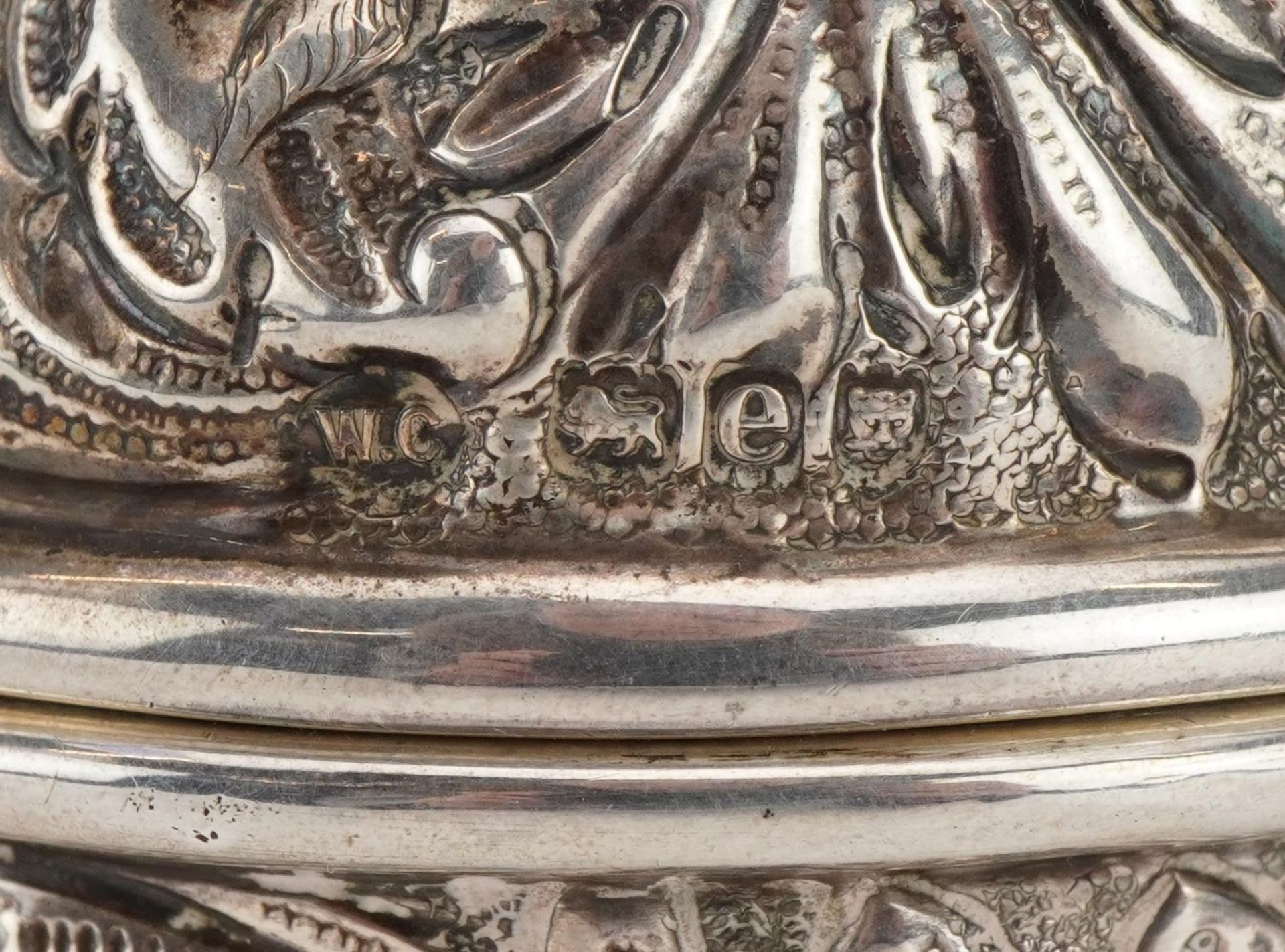 William Comyns, Victorian silver string box embossed with birds amongst foliage raised on three ball - Image 4 of 4