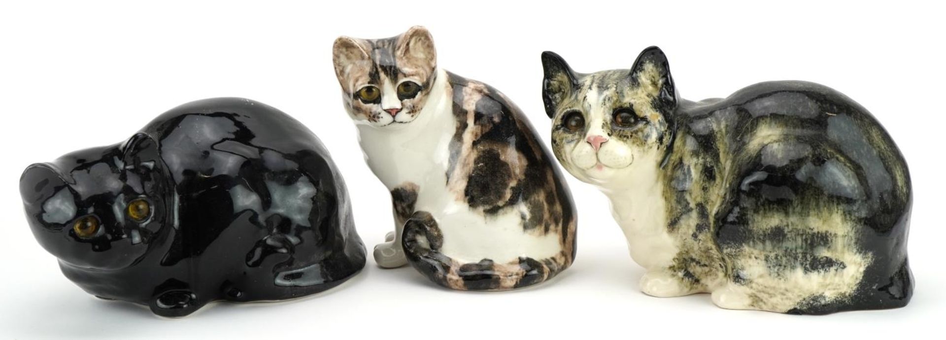 Three Winstanley pottery cats with beaded eyes, the largest 27cm in length