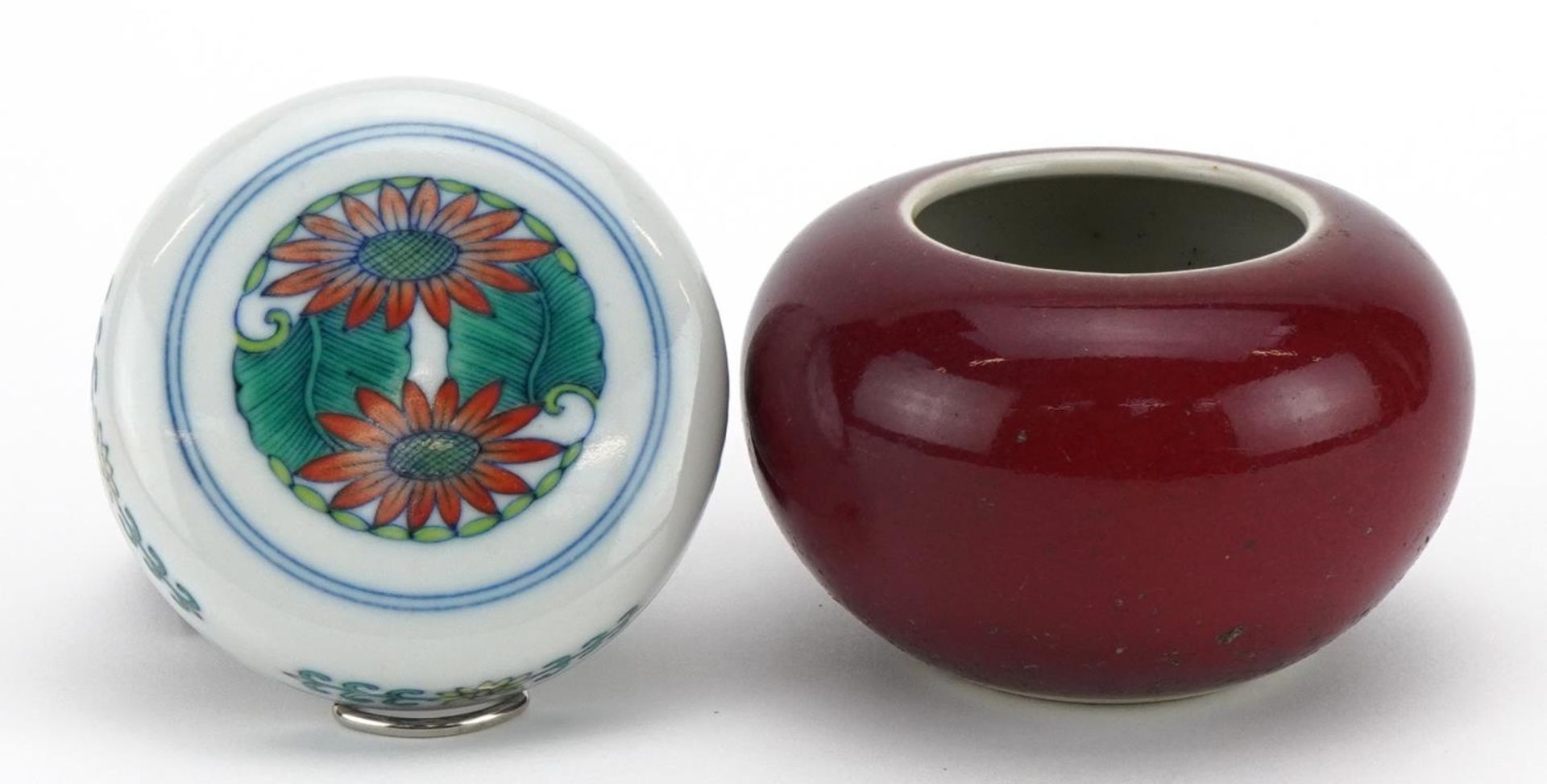 Chinese porcelain brush washer having a sang de boeuf glaze and a doucai lid, the largest 8cm in