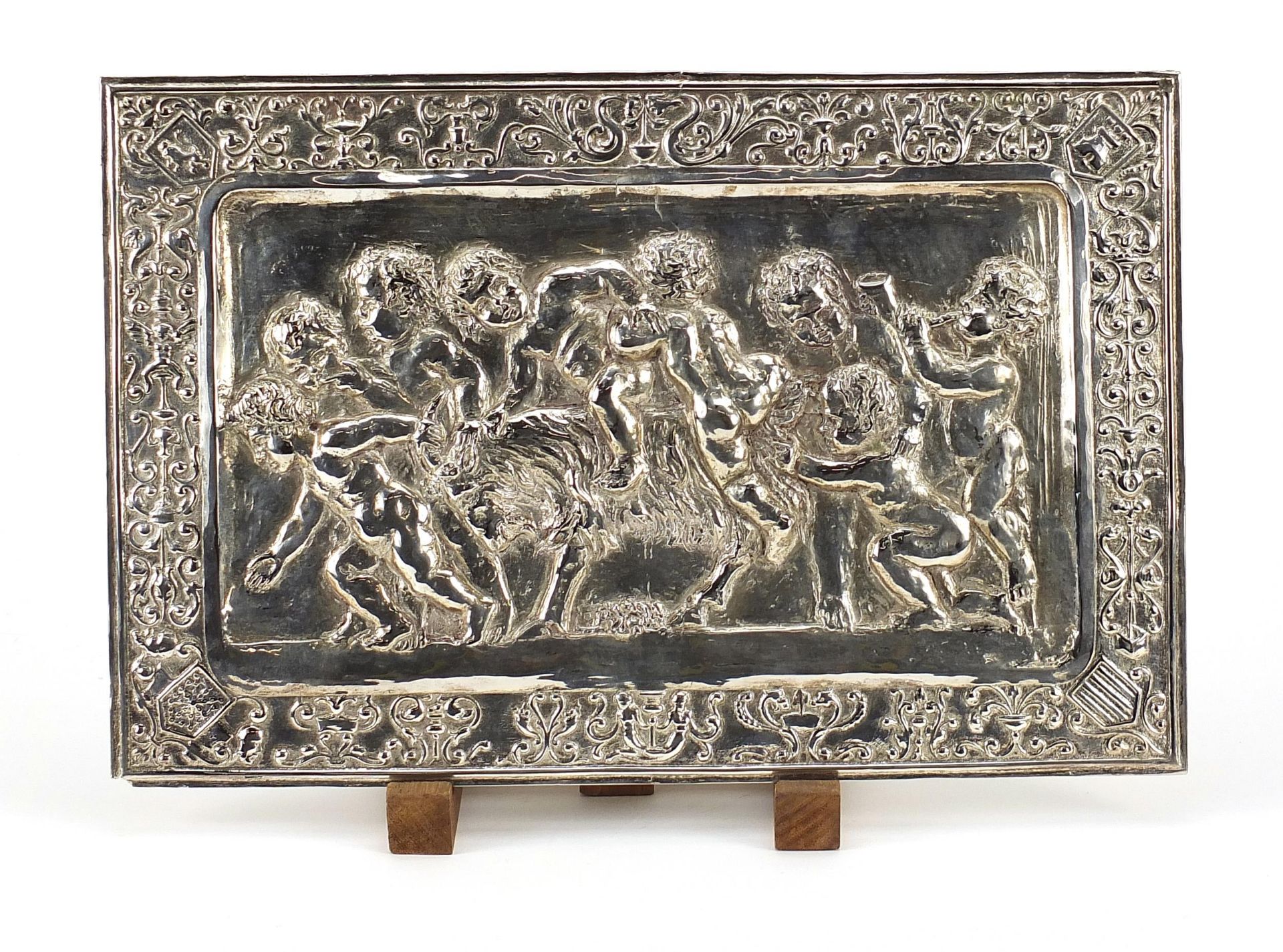 Rectangular continental white metal plaque embossed with Putti, 37cm x 24.5cm