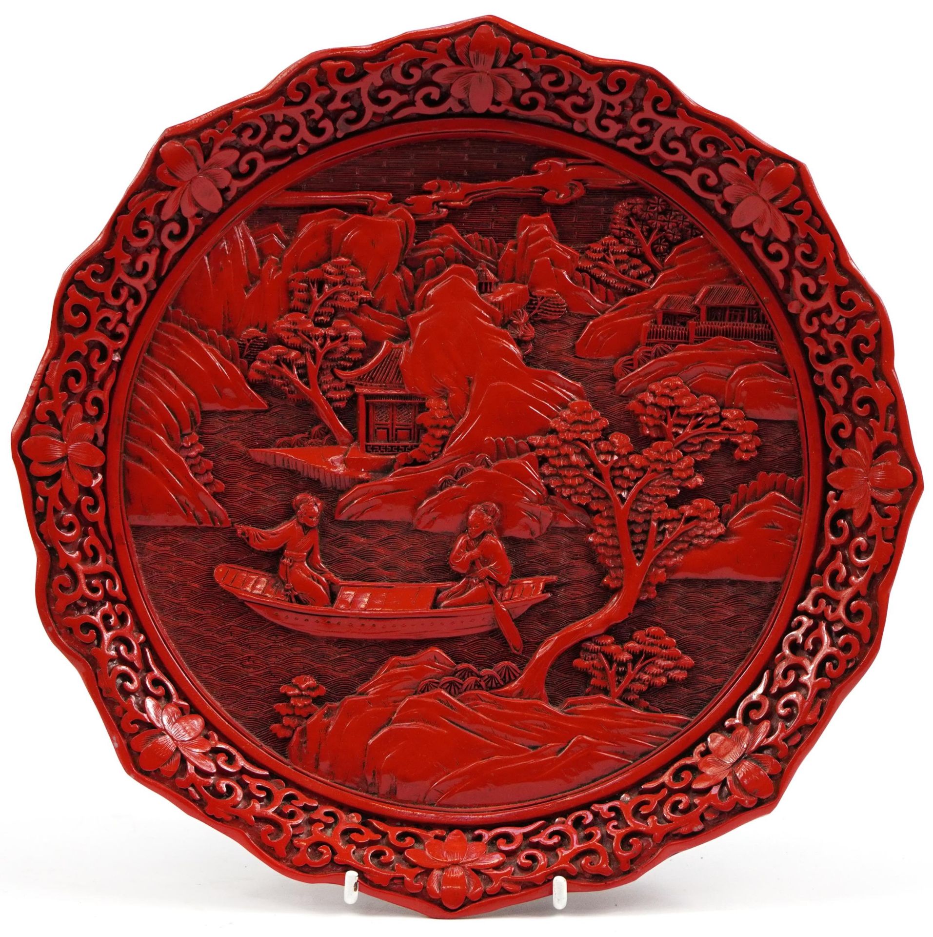 Chinese cinnabar lacquer plate carved with two figures in a boat, 25cm in diameter