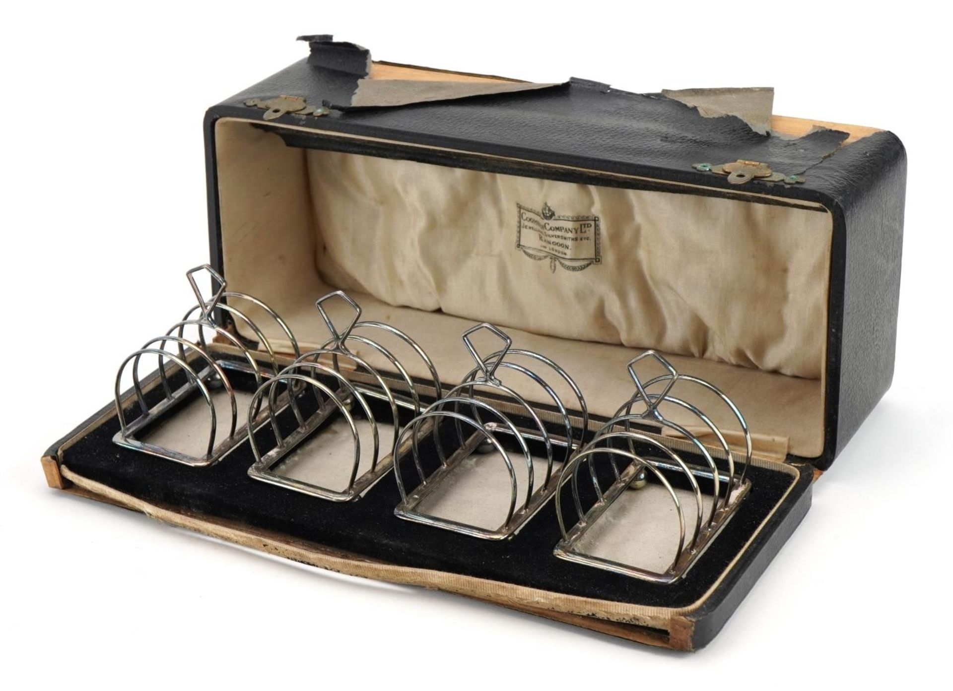 Adie Brothers Ltd, set of four George V silver four sliced toast racks with ball feet housed in a