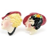 Pair of Art Deco pottery face plaques of females, the largest 18.5cm high