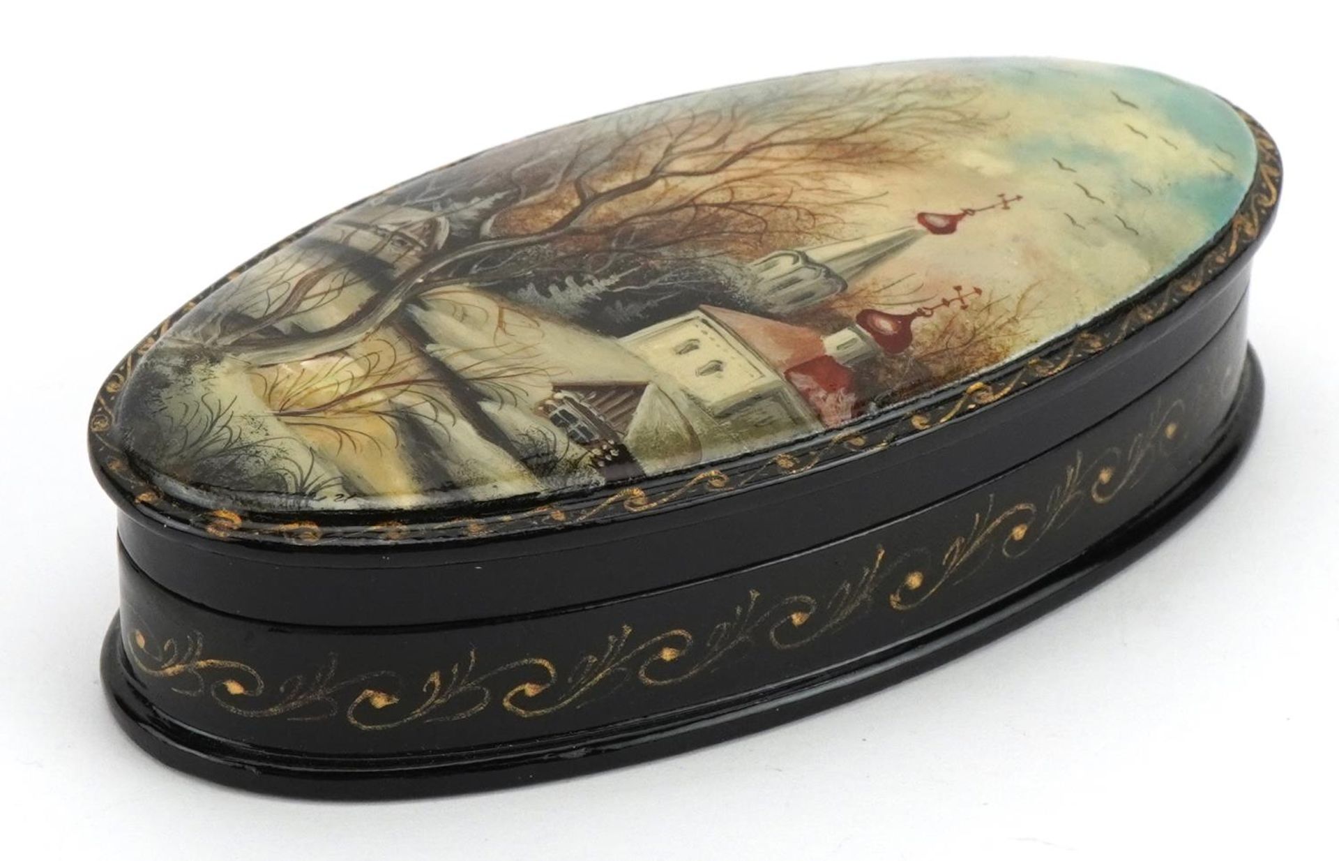 Russian lacquered box with hinged lid hand painted with a snowy landscape, 12cm in length