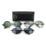 Three pairs of vintage sunglasses including RayBan and Calvin Klein