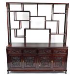 Chinese hardwood wall unit with open shelves above four drawers and two pairs of cupboard doors,