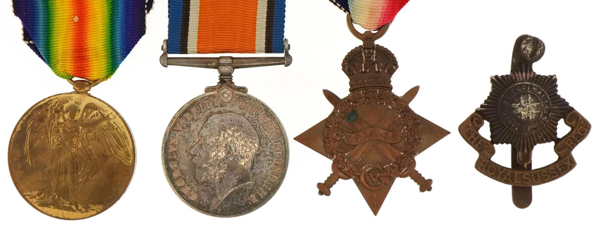 British military World War I trio and Royal Sussex Regiment cap badge, the trio awarded to 5423PTE.